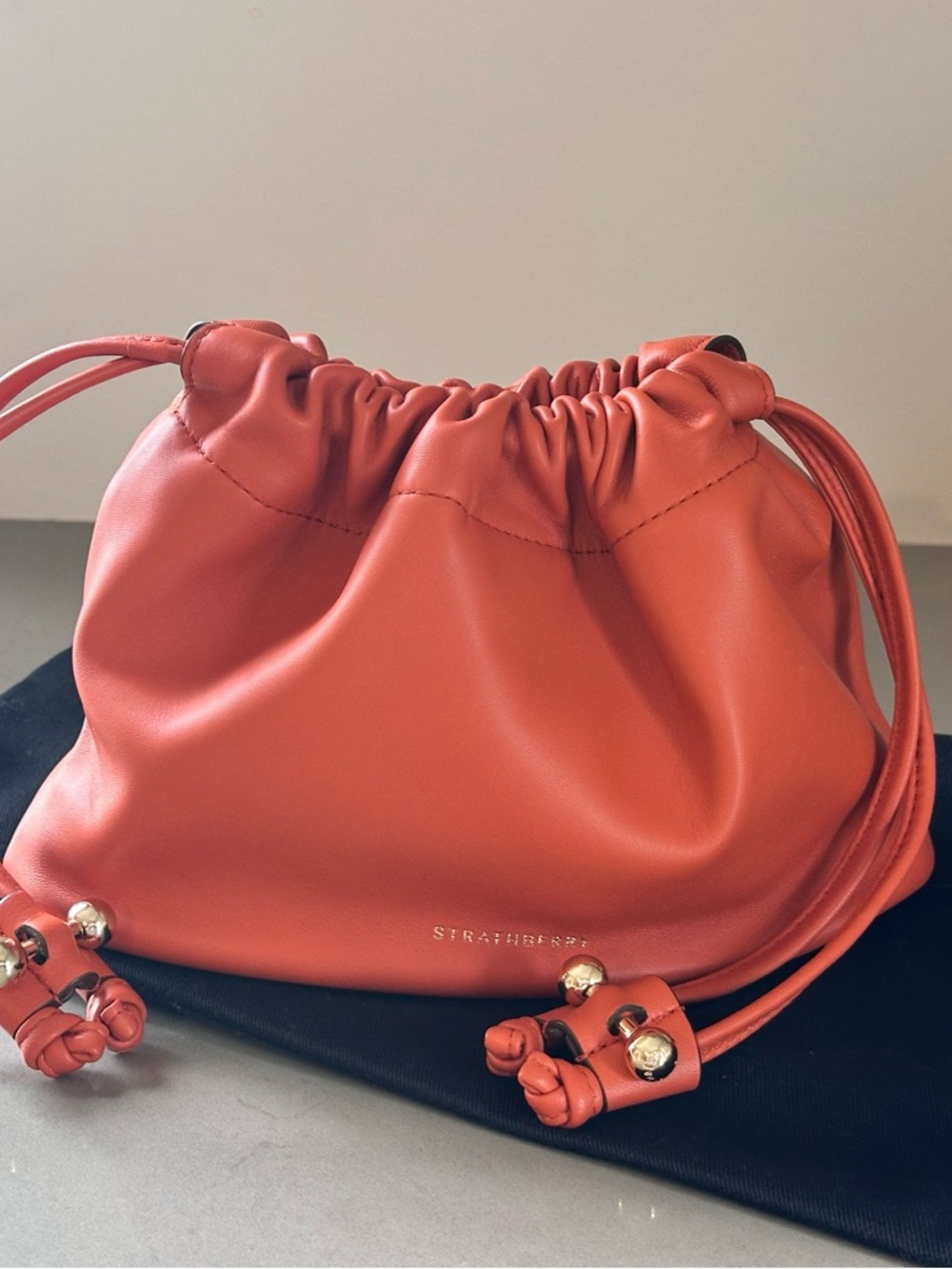 Strathberry Charlotte Orange Leather Drawstring Mini Pouch with Gold Accents